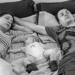 Parents and child sleeping. Photo by David Veksler on Unsplash.