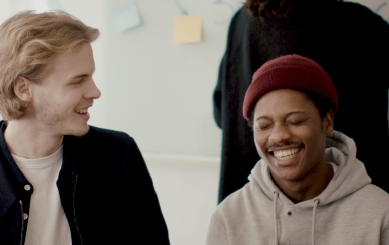 Two happy students in a classroom.